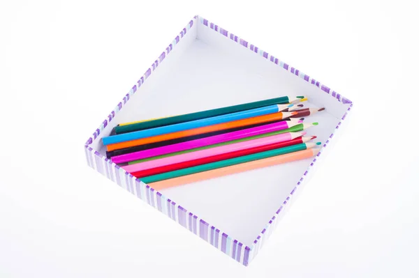 Bright multi-colored pencils in a striped box. kids art — Stock Photo, Image