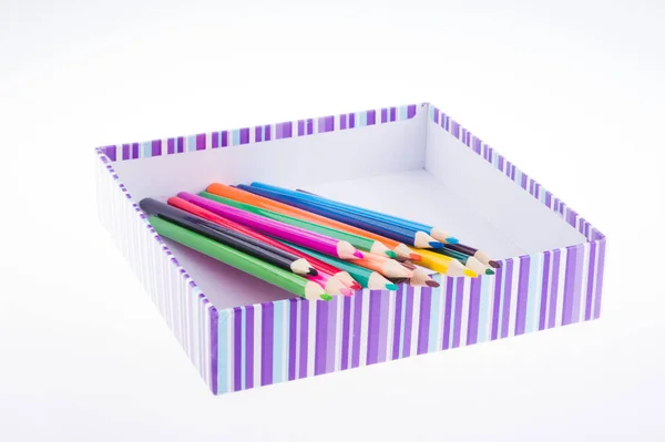 Bright multi-colored pencils in a striped box. kids art — Stock Photo, Image