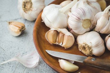 Sarımsak soğanı. Gri arka planda sarımsaklı karanfil.