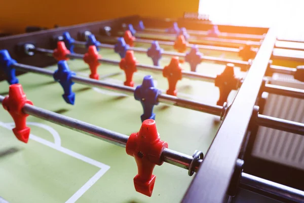 Table football in the entertainment center. Close-up image of plastic players in a football game.