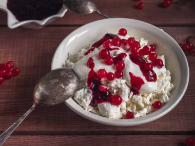 Ekşi Krem ile süzme peynirden hafif kahvaltı, kırmızı frenk üzümü çilek ve ahşap bir tepsi üzerinde reçel, yakın mesafeden vurdu