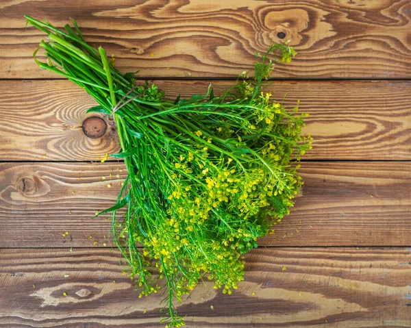 Bouquet of blooming herbs, yellow rape on a wooden table, — Stock Photo, Image