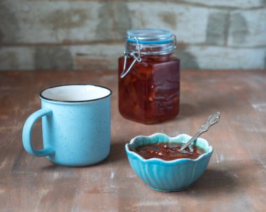 Elma reçelli çay partisi. Cam kavanozda reçel ve kırsal mutfak masasında reçel.