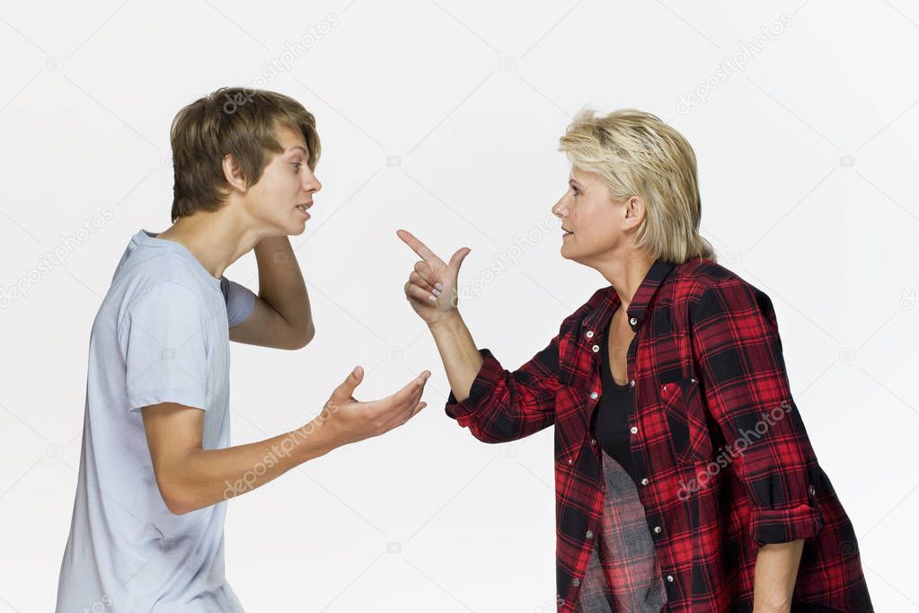 Mom and a teenage son are arguing with each other against white background