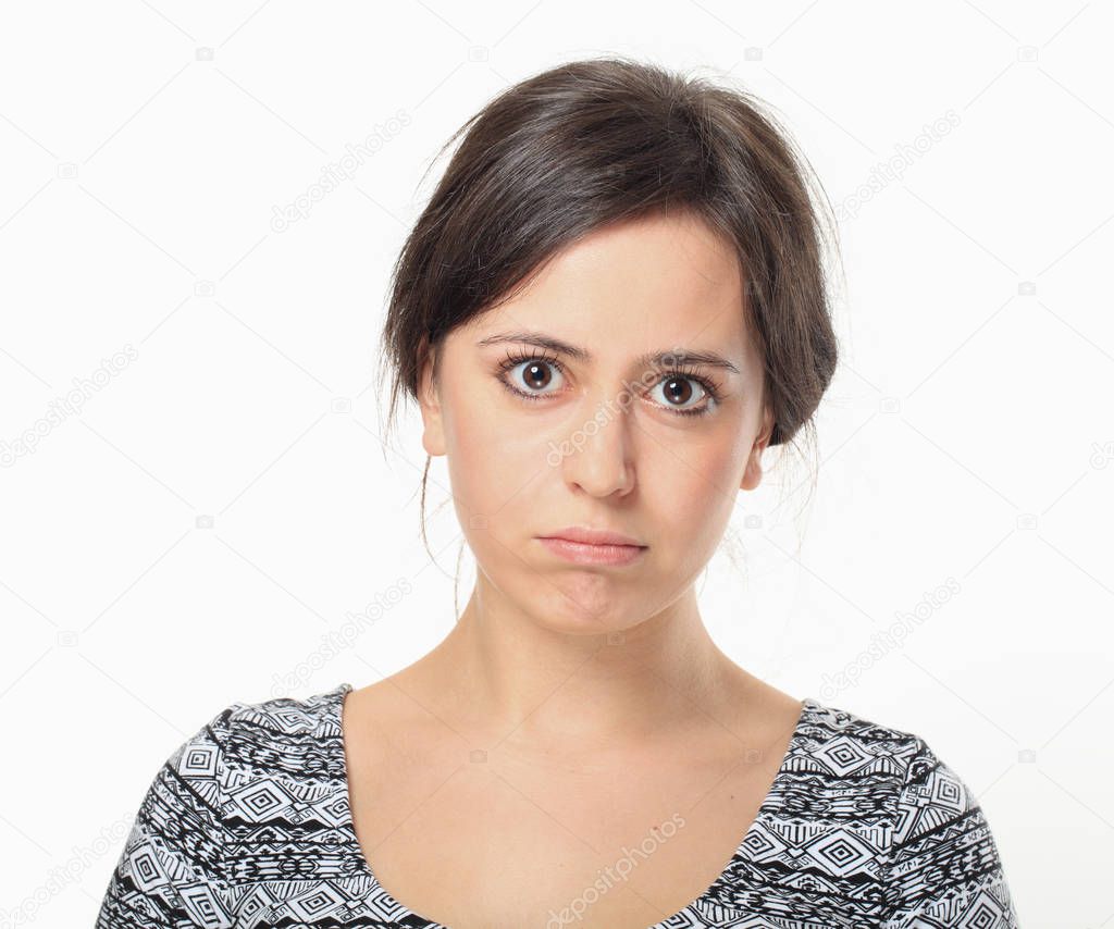 Portrait of sad young woman looking at cameraman