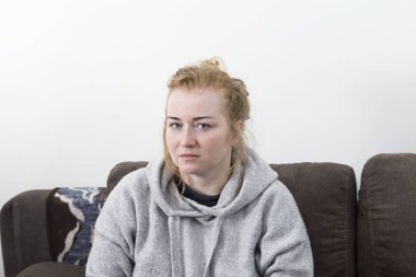 Baş ağrısı olan kadın. Ev hanımı kadın baş ağrısı ve alnına bir el ile bir kanepe.