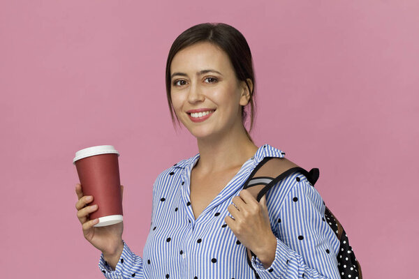 Beautiful and charming female student with backpack and cup of coffee