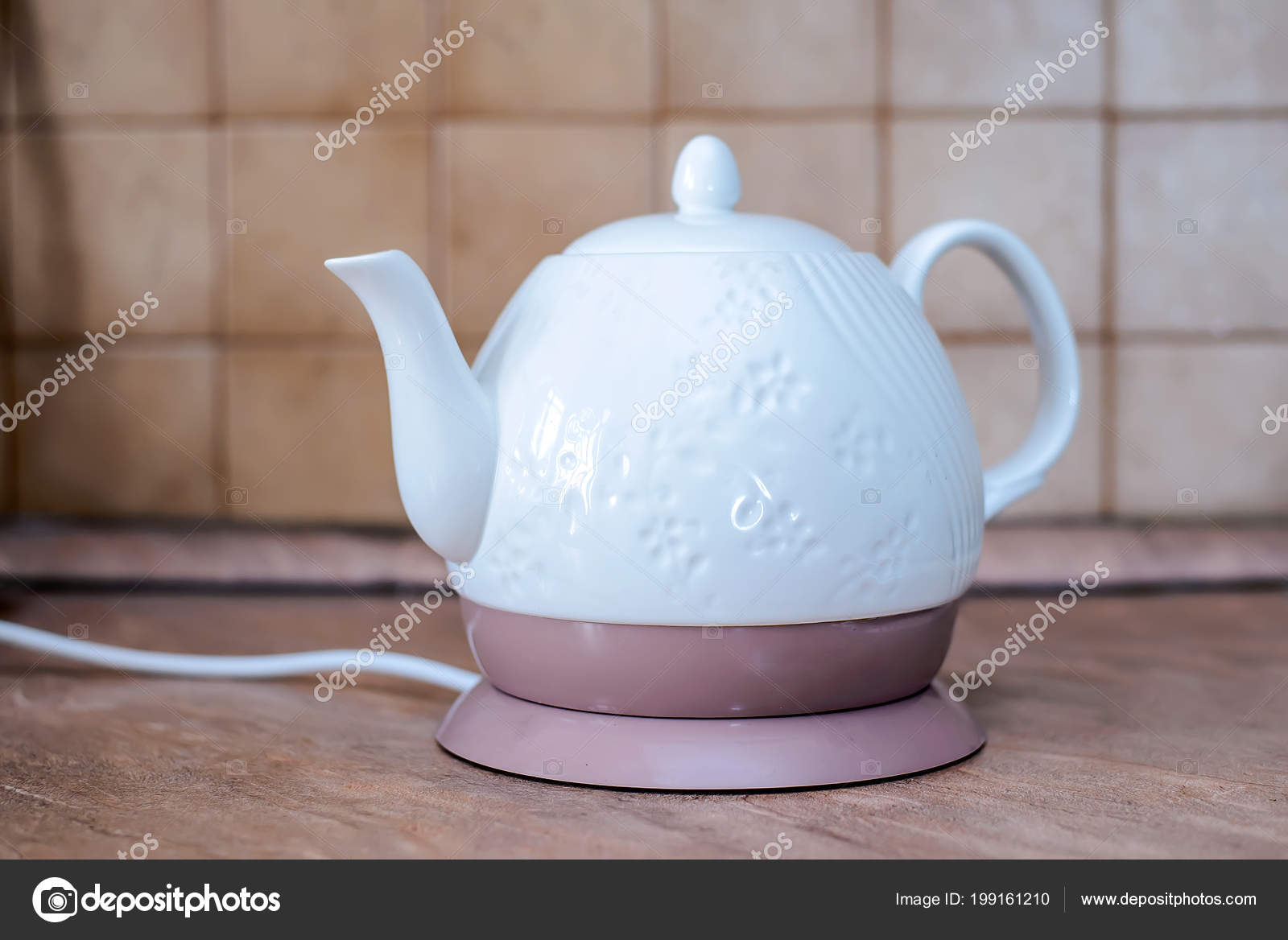 White Ceramic Electric Kettle Stand Kitchen Table Stock Photo by