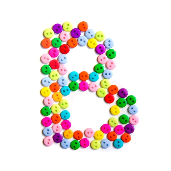 Письмо В английского алфавита из разноцветных кнопок — стоковое фото