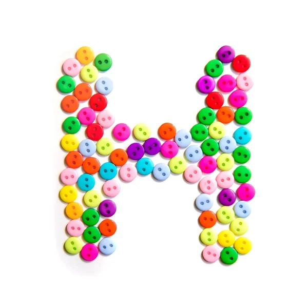 Буква H английского habet сделана из разноцветных пуговиц — стоковое фото