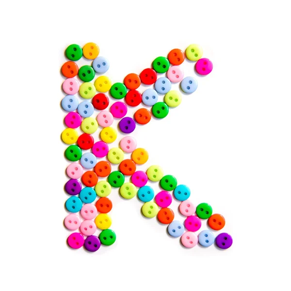 Буква К английского habet сделана из разноцветных пуговиц — стоковое фото