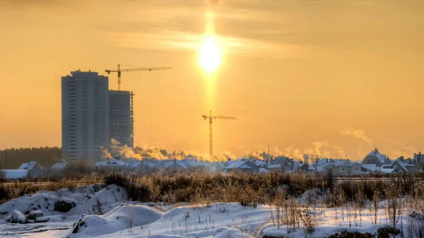 Dawn amid villages and modern houses on the outskirts of Yekaterinburg in winter