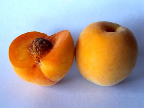 Close-up of one and a half organic peaches.