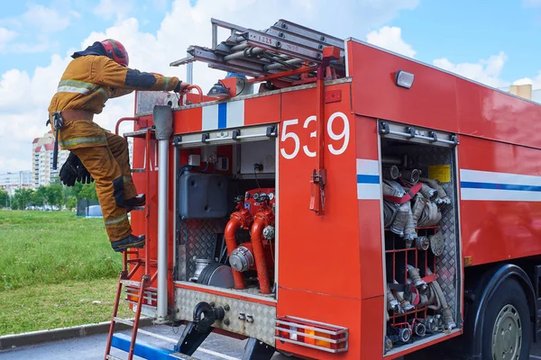 Firefighter down the fire truck on the stairs for any purpose