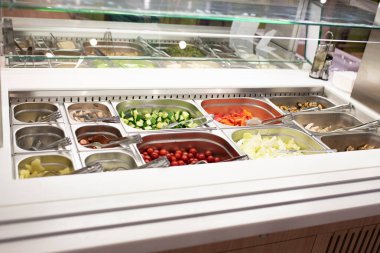 Geniş bir dükkanda self-servis salata barı