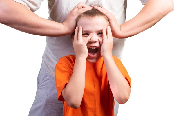 A little boy looks at the phone, and is surprised. Isolated on a blue background. — Stock Photo, Image