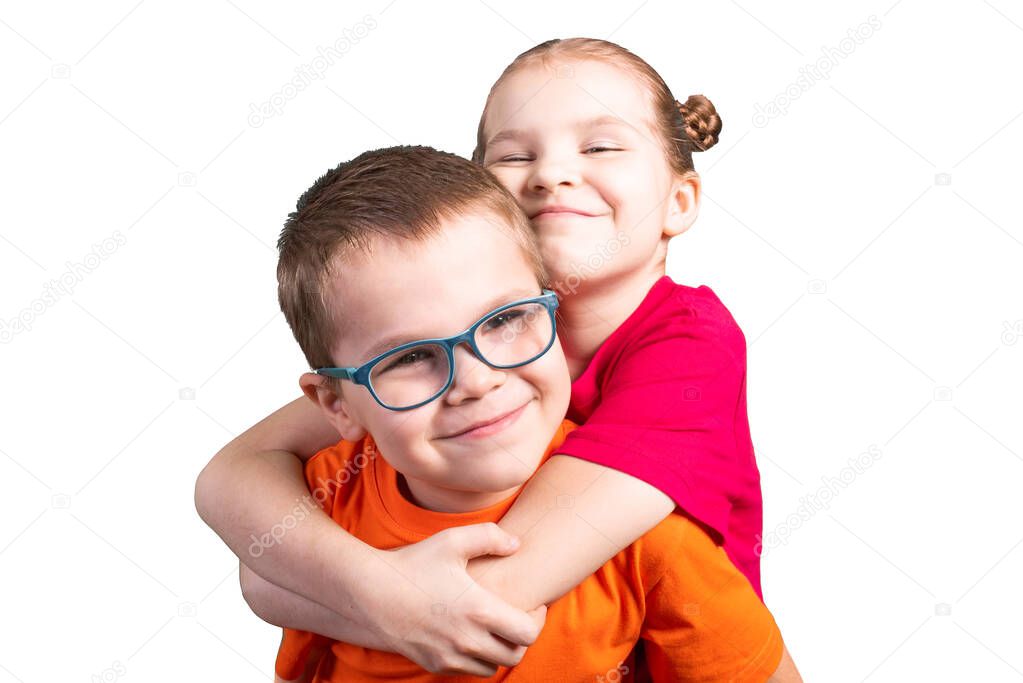 Brother and sister hugging and smiling. Isolated on a white background.