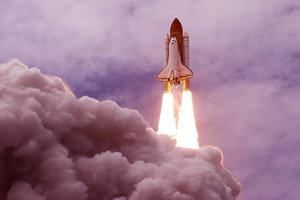 Space Shuttle Launch. With fire and smoke. Against the background of blue sky. Elements of this image were furnished by NASA.