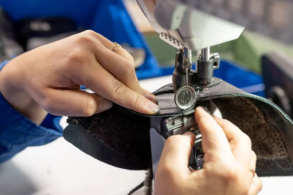 The process of sewing shoes on a sewing machine. Shoe production.