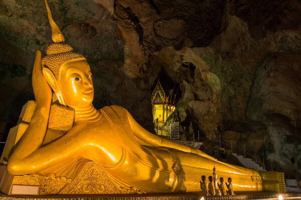 The golden reclining Buddha of Thumb Suwanna Kuha temple in Phang Nga province. the temple is inside the cav