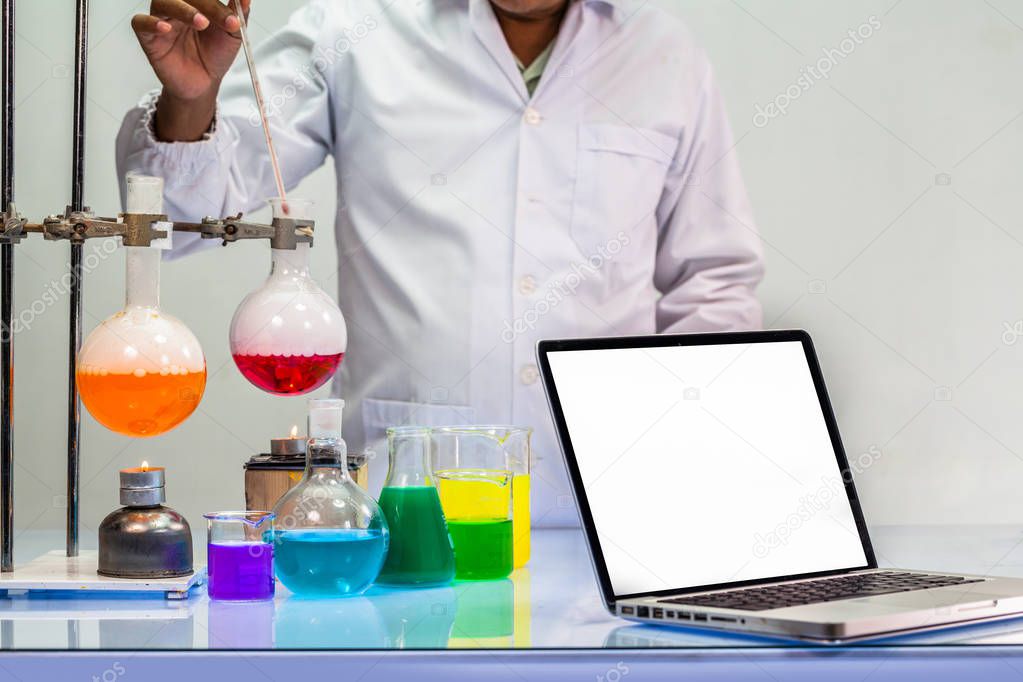 a scientist work on computer in chemical mixing in laboratory experiments with copy space