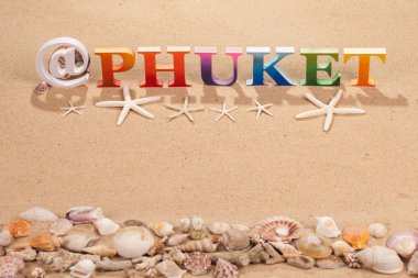 @Kopya alanı ile sahilde deniz kabuğu ile renkli ahşap harflerle yazılmış Phuket