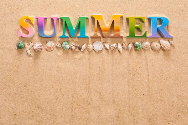 summer written in colorful letters decorate with starfish on the beach with copy space