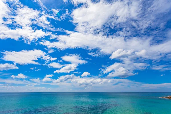 white cloud  in blue sky above the ocean