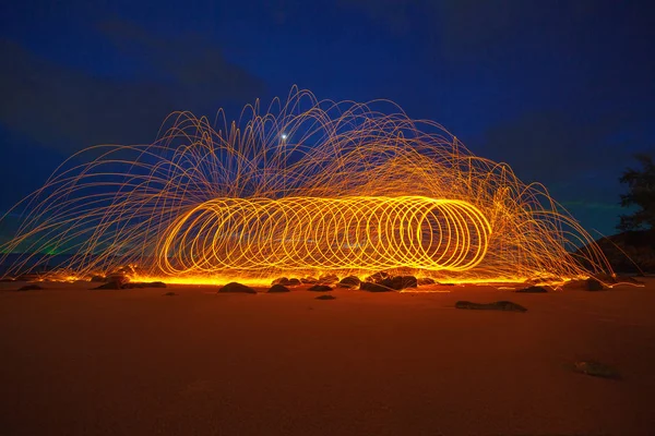 steel wool fire work on the rock.cool burning steel wool fire work photo experiments on the rock at sunrise.