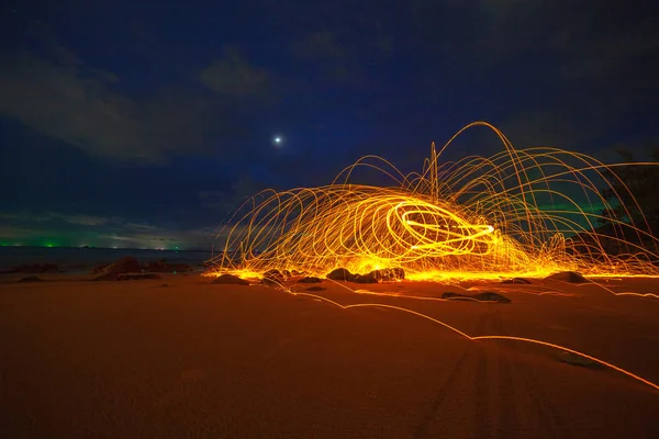 steel wool fire work on the rock.cool burning steel wool fire work photo experiments on the rock at sunrise.