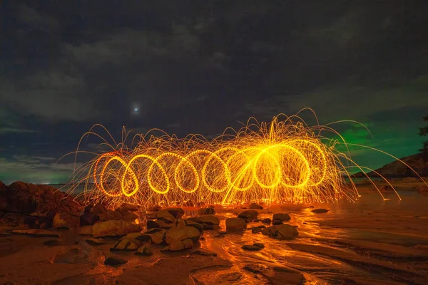 steel wool fire work on the rock.cool burning steel wool fire work photo experiments on the rock at sunrise.