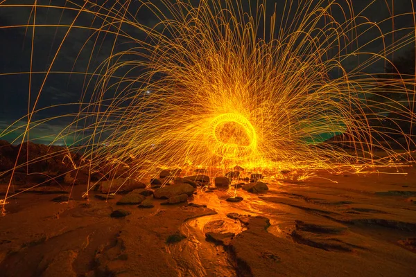 steel wool fire work on the rock.cool burning steel wool fire work photo experiments on the rock at sunrise.