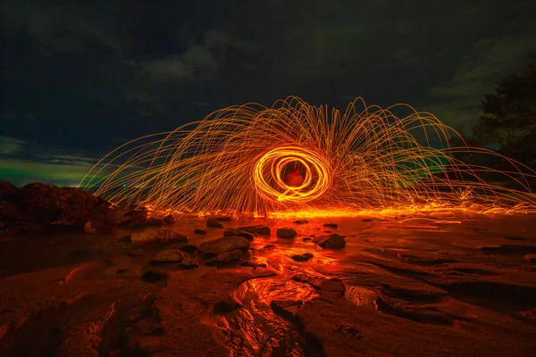 steel wool fire work on the rock.cool burning steel wool fire work photo experiments on the rock at sunrise.