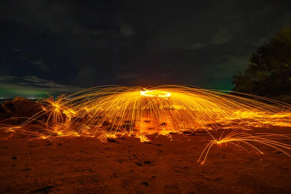 cool burning steel wool art fire work photo experiments on the beach at sunset