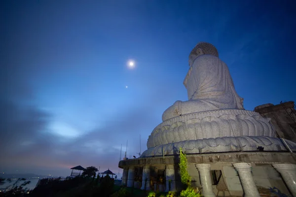 moon and star above the head of Phuket big Bubbha brfore sunrise