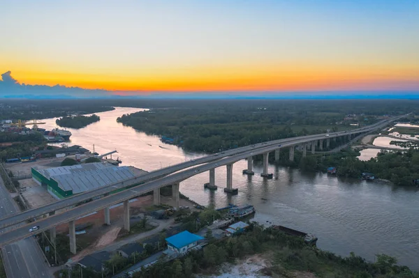 aerial photography sunset above Sri Surat bridge across Tapee river Surat Thani Thailand