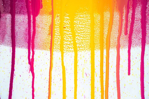 colors of printing ink purple, pink, orange, yellow and magenta colors are dripping on white paper.