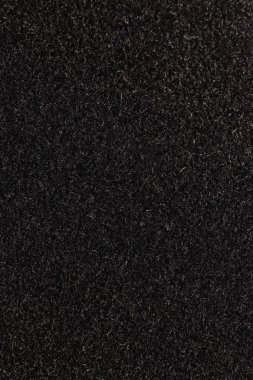 Siyah yumuşacık malzeme doku. Karanlık detaylı lifleri kabarık yüzey arka plan.