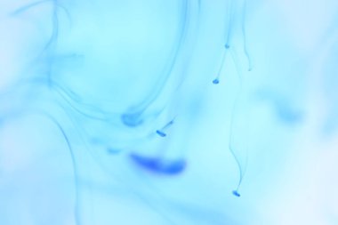 Temiz su içinde mavi mürekkep damlar. Yumuşak ortam arka plan.