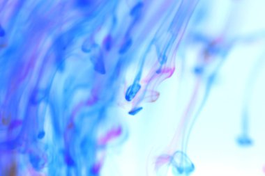 Renkli mürekkep mistik dinamik hareket suya düşüyor. Ortam yumuşak arka plan.