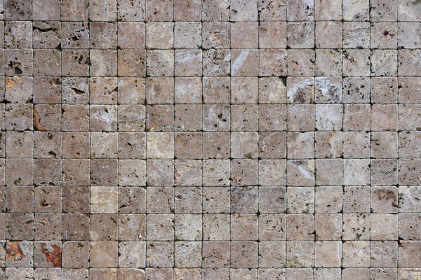Square stones surface background. Travertine masonry tiles cladding wall texture.