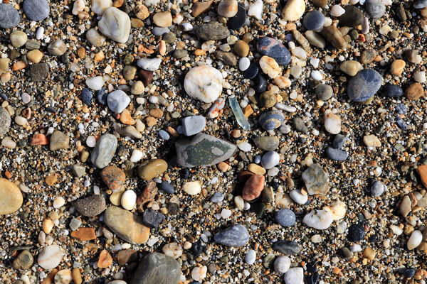 Different stone pebbles on the beach. Nautical marine background.