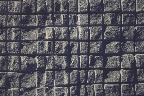Sawn in a squares blue granite wall texture. Granite surface bac