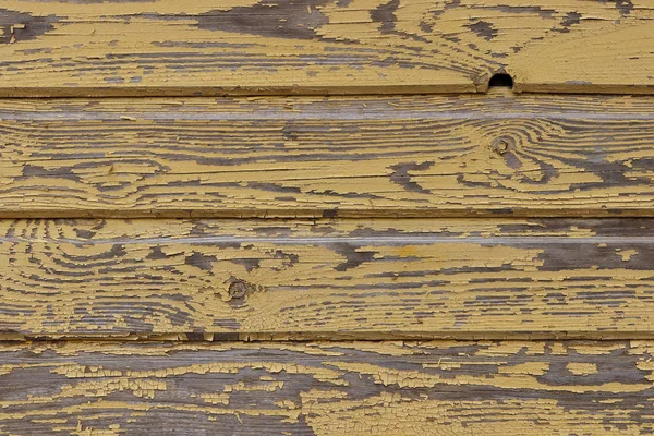 Viharzott sárga festék deszka fal — Stock Fotó