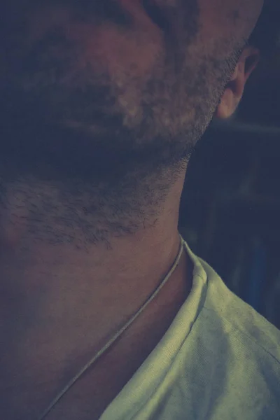 Mans neck and chin with stubble.