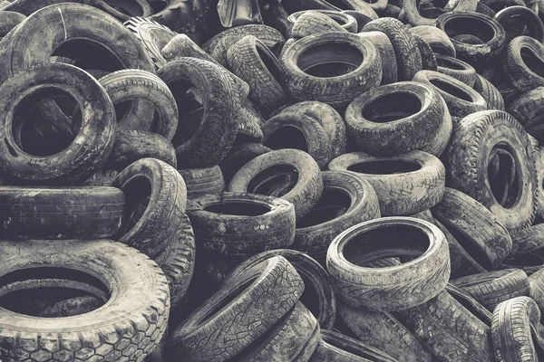 Old tyre recycling background. Tire trash texture.