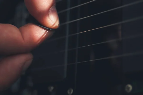 Playing the guitar. Guitarist's hand dynamic motion. Musical lifestyle background. Macro closeup. — Stock Photo, Image