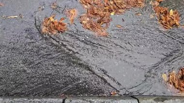 autumn rainy season. streams of rainwater on the old streets of the city.