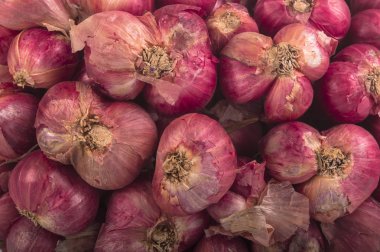 Beyaz arkaplanda izole edilmiş bir gruptaki Shallot soğanları.