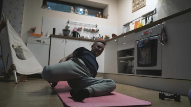Όμορφος άνθρωπος άσκηση στην κουζίνα στο σπίτι — Αρχείο Βίντεο